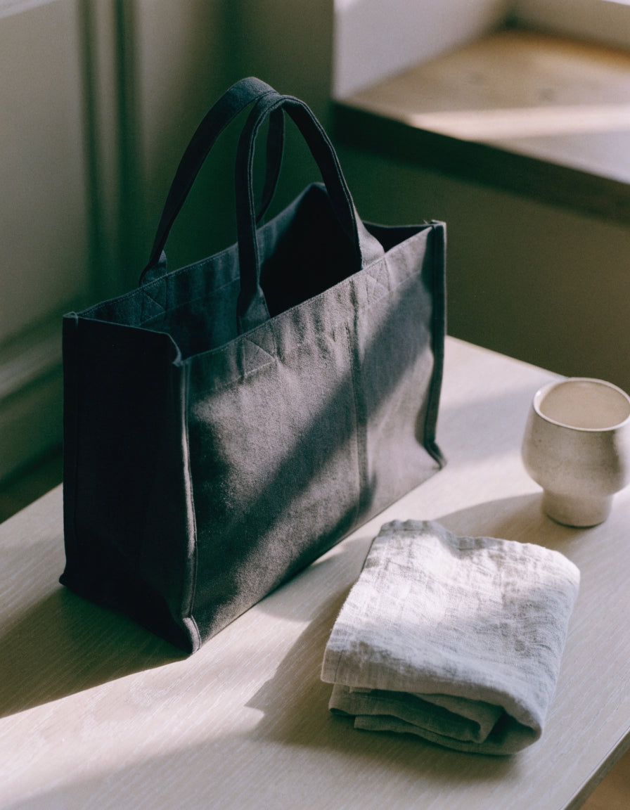 Structured tote bag on a pale wooden table in soft window light — Vessa Bags Totes and Handbags collection